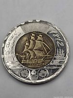Reverse side of 2012 War of 1812 toonie showing full ship design and overall wear