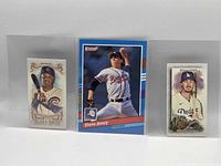Front views of all three sleeved cards side by side