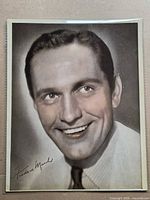 Front of photograph showing male portrait, signature visible