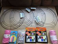 overview of 3 wreath frames, face paints, yarn rolls, candle pack, confetti bag