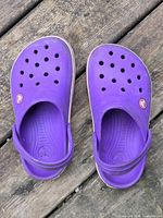 Top view of both purple Crocs clogs displaying overall condition and color