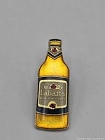 Front view of Labatt's beer-bottle enamel pin
