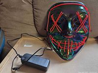 Front view of iridescent EL wire mask with battery pack