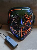 Front view of mask unlit with battery pack shown