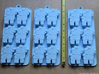Three identical light blue silicone llama mold trays side by side