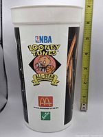 Front view showing NBA Looney Tunes All-Star Showdown logo and McDonald's Sprite branding with ruler indicating height