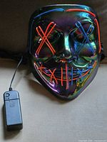 Front view of illuminated EL mask with battery pack attached