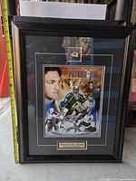Entire framed Patrick Roy print showing frame, pin, plaque, and tape measure for scale