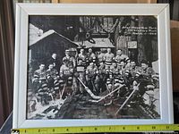 Full view of framed reproduction hockey team photograph with measuring tape