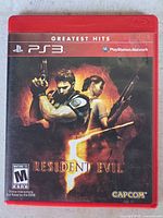 Front of red PS3 case showing game title, Capcom logo, ESRB rating