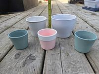Front view of all five ceramic pots showing sizes and colors