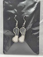 Front view of earrings on display card inside plastic sleeve