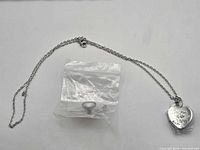 Necklace laid out with bagged pin and jump ring