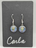 Front view of earrings on display card showing overall design