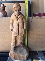 front view showing full figurine with tape measure indicating height