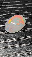 Top view of oval Ethiopian fire opal showing play-of-color