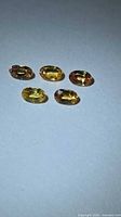 Five oval sapphires on neutral background showing color range