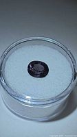 Top view of electric purple oval spinel in display case
