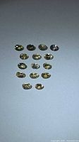Group of 15 oval faceted champagne-tone Tanzanite gemstones on light background