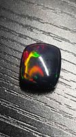 Front view of black opal showing multicolour fire