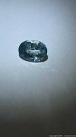Top view of oval lagoon blue zircon showing facets