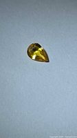 Top view of pear-shaped yellow sapphire