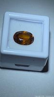 Zircon in display box showing face-up color and cut