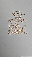 Scattered view of round champagne sapphires on neutral background