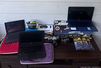 Overall view of laptops, VR viewers, model airplane box, cameras and SIMCard Wizards on table
