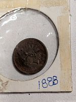 Coin in cardboard flip, full view