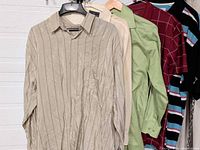 Full view of five shirts hanging