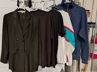All six clothing items hanging on rack