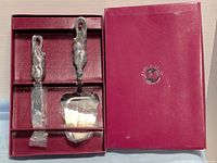 Box open showing cheese knife and plane with protective plastic