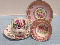 Both cup and saucer pairs standing together