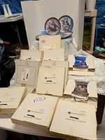 Overall lot with stacked boxed plates and two opened plates