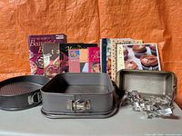 Full lot showing books, pans and cookie cutters
