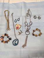 All eight jewellery pieces laid out on cloth for full view