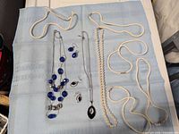 Overview of all necklaces and earrings on cloth