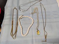 Group of five necklaces laid out