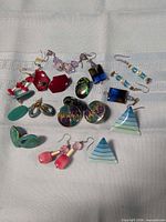 Group shot of all earring pairs displayed on cloth
