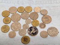 Full group of assorted coins displayed on fabric