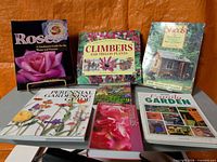 All seven gardening books laid out – front covers visible