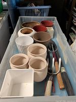 Overall view of tote showing assortment of planters and tools