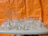 Group of assorted glass and crystal pieces on table
