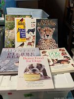 All seven books displayed together on tote lid