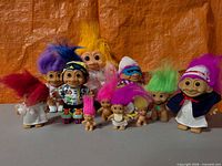 All troll dolls arranged to show variety of sizes, outfits and hair colors
