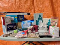 Overall view of mixed household supplies and décor on table