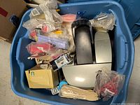 Overview of tote with Keurig brewer, coffee packets, cutlery and supplies
