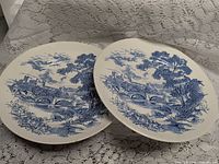 Pair of Wedgwood blue transfer plates showing rural bridge scene