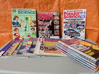 Front view showing three representative magazine covers and two stacks of additional issues